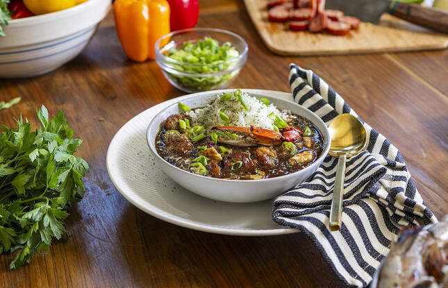 Bowl of Louisiana Seafood Gumbo surrounded by gumbo ingredients