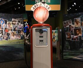 An exhibit at the Capitol Park Museum, featuring an old gas pump with a pelican sitting on top.