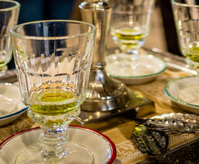 An ornate tray holds three cups with a few ounces of absinthe, a bright green liquid, at La Galerie de l'Absinthe at the Southern Food &amp; Beverage Museum.