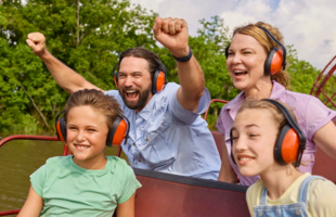 A family of four looks jovial as they cruise aboard an airboat in Louisiana.