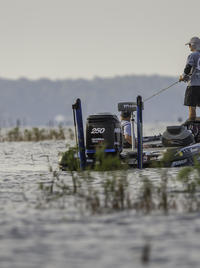 An angler fishes for bass on Toledo Bend in a motor boat.